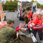 Soldiers from Medical Regiment 2 hand over a treated patient to the German Red Cross during the first Rhineland-Palatinate State Exercise Day 2025 in Montabaur.